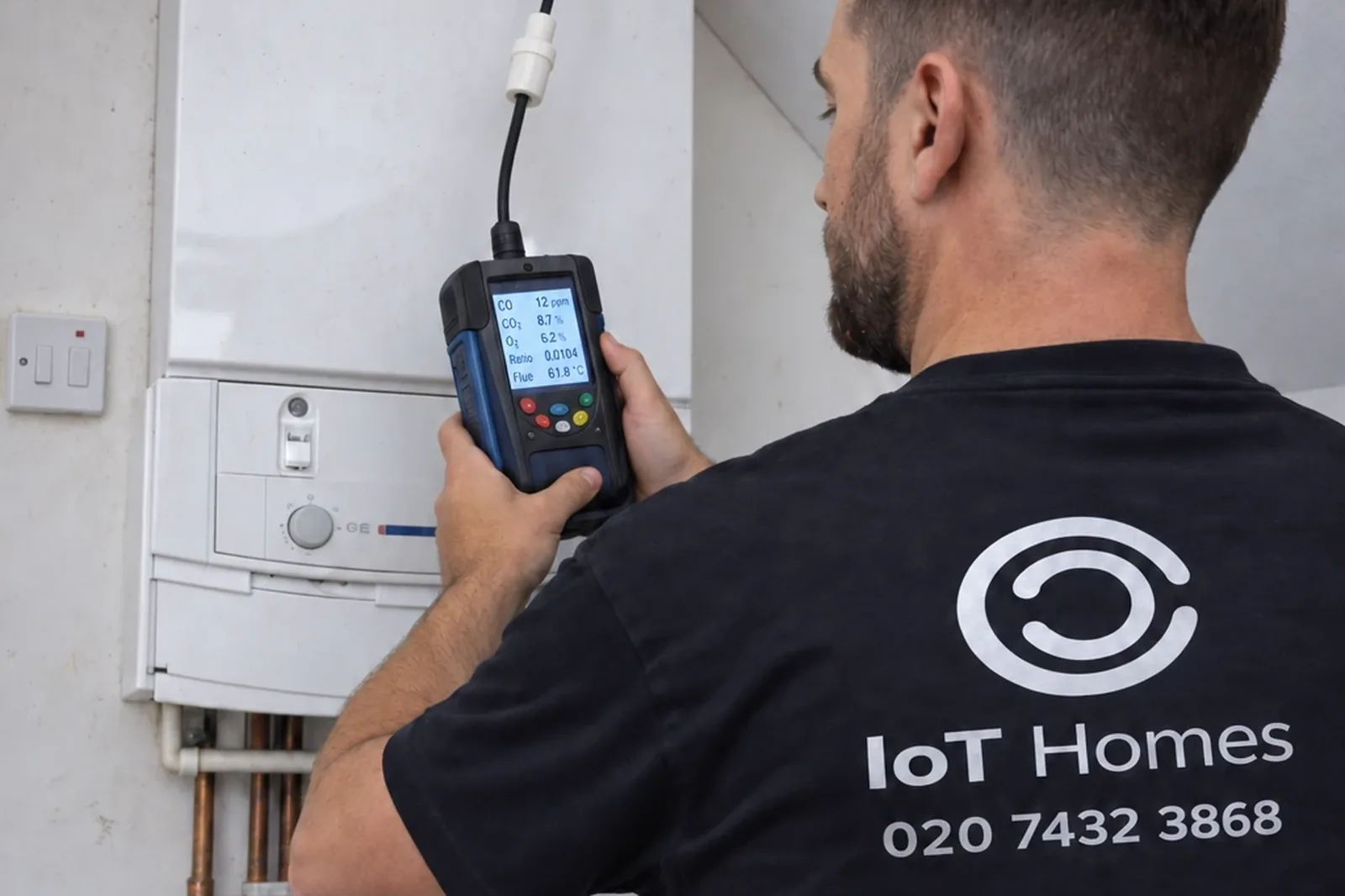 An IOT Homes engineer checking a boiler with a flue gas analyser